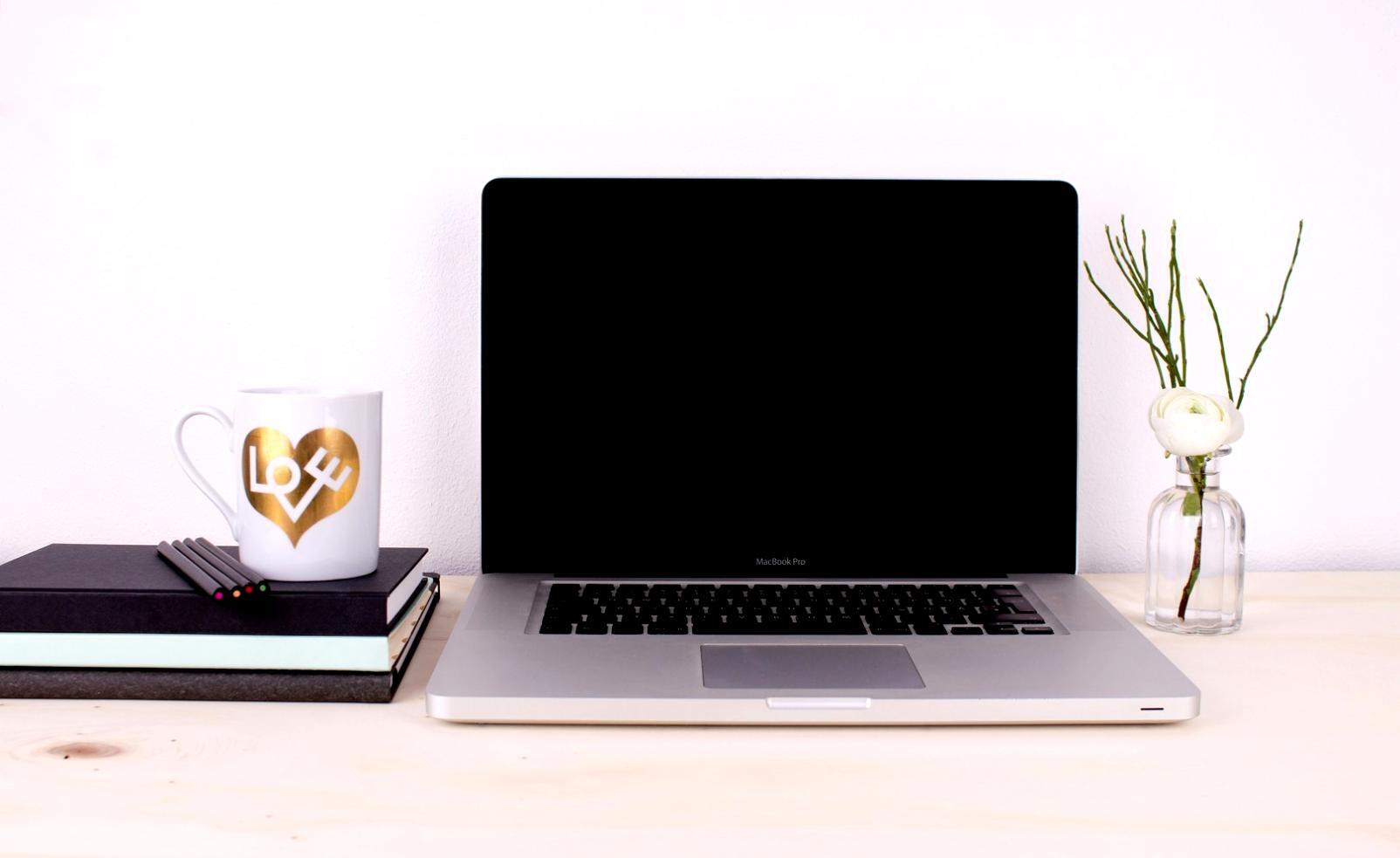 Well-organized creative workspace with dual monitors and design materials